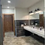 A long shot of the bathroom with wooden door