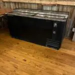 A bar cooler on the wooden flooring